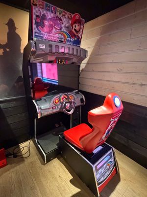 a video game machine with a steering wheel and a video game console