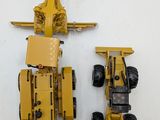 two toy vehicles that are sitting next to each other