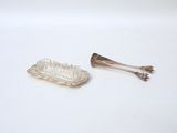 pair of silver plated hair combs on a white surface