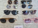 several pairs of sunglasses on a table with a price tag