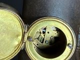 a close up picture of a clock on a table