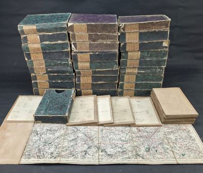 several old books stacked on top of each other on a table