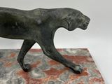 bronze sculpture of a dog on a marble base