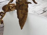 a gold goat head on a white plate on a table