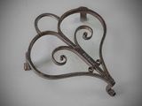 a metal hook with a heart shaped design on it