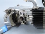 a close up of a motorcycle engine with a blue hose