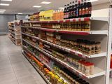many shelves in the store with various foods on them