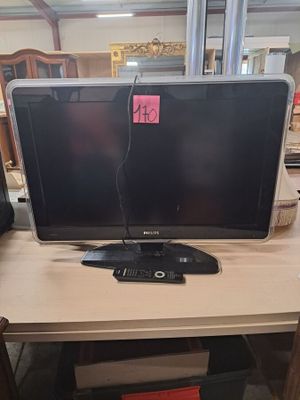 un écran d'ordinateur posé sur un bureau en bois