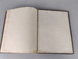 an open book sitting on top of a table next to a white table
