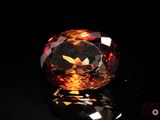 a close up of a fancy colored diamond on a black surface