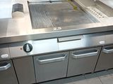 a large kitchen with stainless steel appliances and a sink