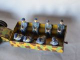 a toy truck that has a group of soldiers in it