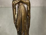 statue of a woman holding a baby in her arms on a glass table