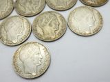 some very old coins are laying on a white surface