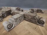 several pieces of wood are stacked on top of each other on a wooden floor