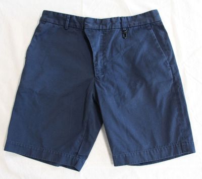 a close up of a pair of shorts laying on a bed