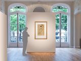 a sculpture of a man standing in front of a painting in a room