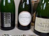 several bottles of wine and a bottle opener sitting on a table
