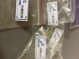 four bags of food sitting on a table with labels on them