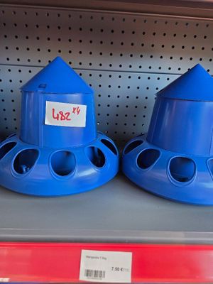 two blue bird feeders sitting on a shelf in a store