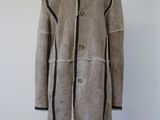 an image of a woman ' s coat on a mannequin stand