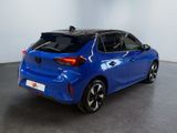 the rear end of a blue car in a showroom