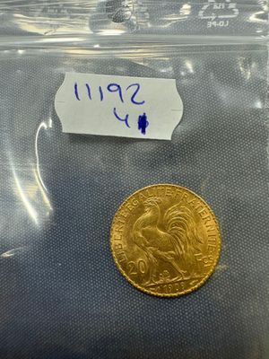 a close up of a gold coin in a plastic bag on a table