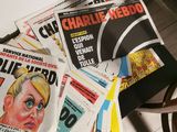 several newspapers on a table with a chair and a chair in the background