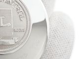 a close up of a watch with a coin on it