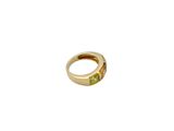 an image of a gold ring with a peridot stone in it