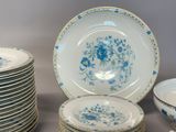 a lot of plates and bowls sitting on a table