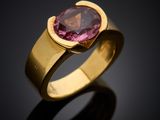 a close up of a gold ring with a pink tourmaline stone