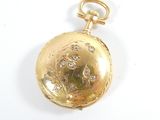 a gold pocket watch with diamonds on it