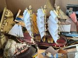 a wooden model of a sailboat in a box