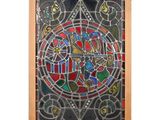 a close up of a stained glass window in a wooden frame