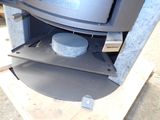 a stove with a pan inside of it on a pallet