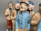 many figurines of people that are standing together