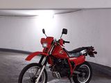 a red motorcycle that is parked in a parking garage