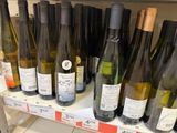 many bottles of wine sitting on a shelf in a store