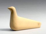 a small wooden bird that is sitting on a table