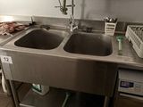 a kitchen with a sink and a dishwasher in it