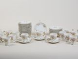 a lot of plates and cups and saucers on the table
