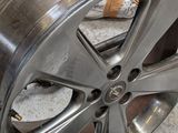 a wheel that has been painted silver and is sitting on the floor