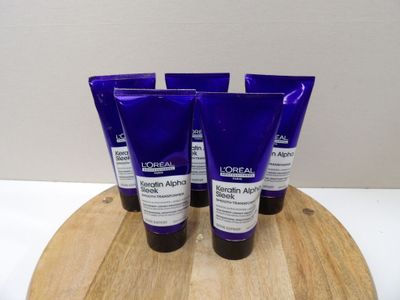 trois flacons de crème hydratante posés sur une planche en bois