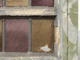 a cat sitting on the window sill of a run down building