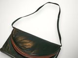 a black and brown leather purse with a brown strap