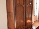 a large wooden cabinet in the middle of a room