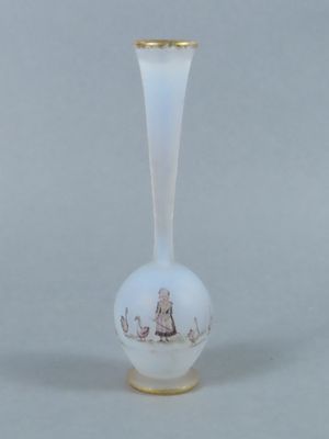 a white vase with a gold rim and a picture of a woman on it