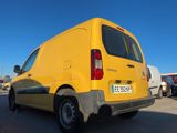 a yellow van that is parked in a parking lot