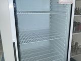 an empty refrigerator in the middle of a room